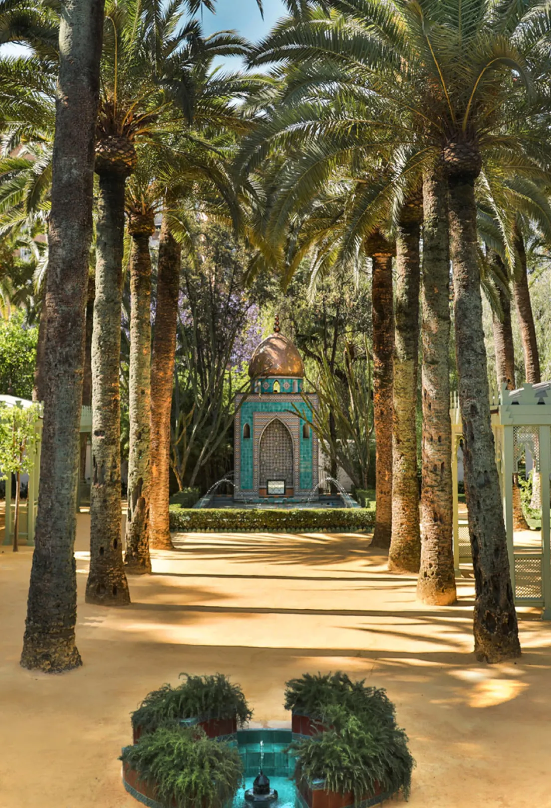 Palm alley leading to a pavilion